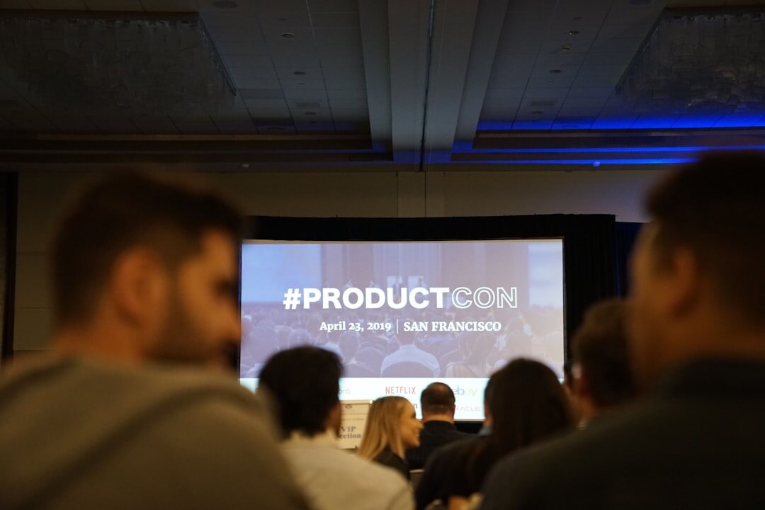 Technology conference with audience and large presentation screen
